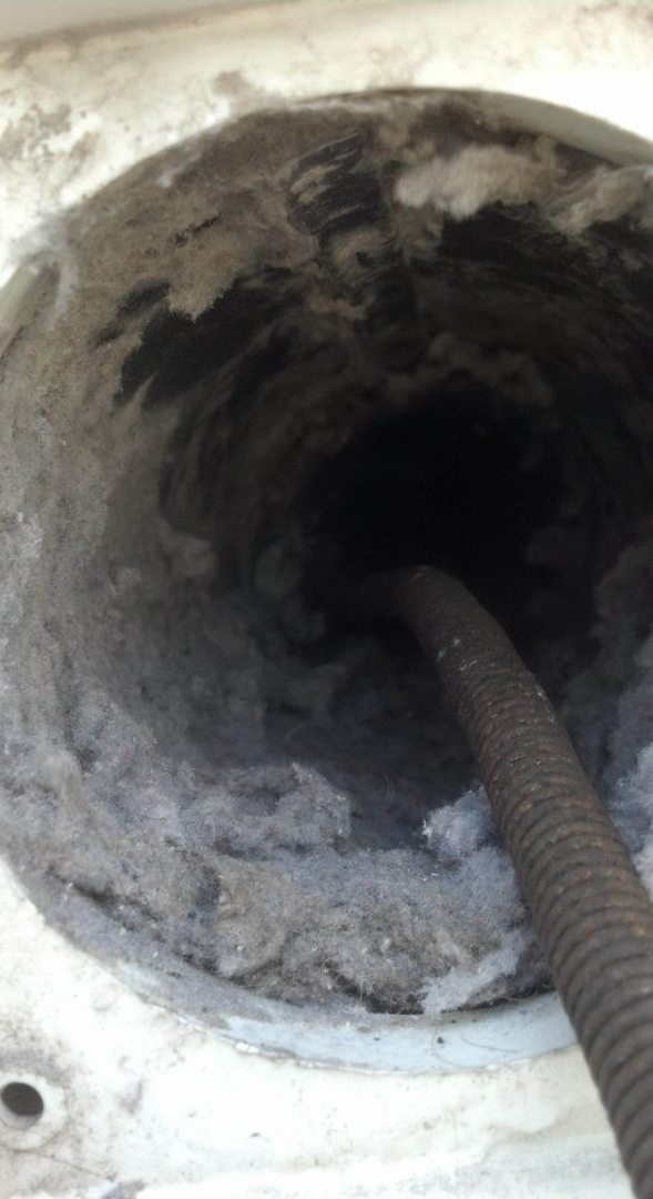 Dryer vent before clean-out, packed with lint