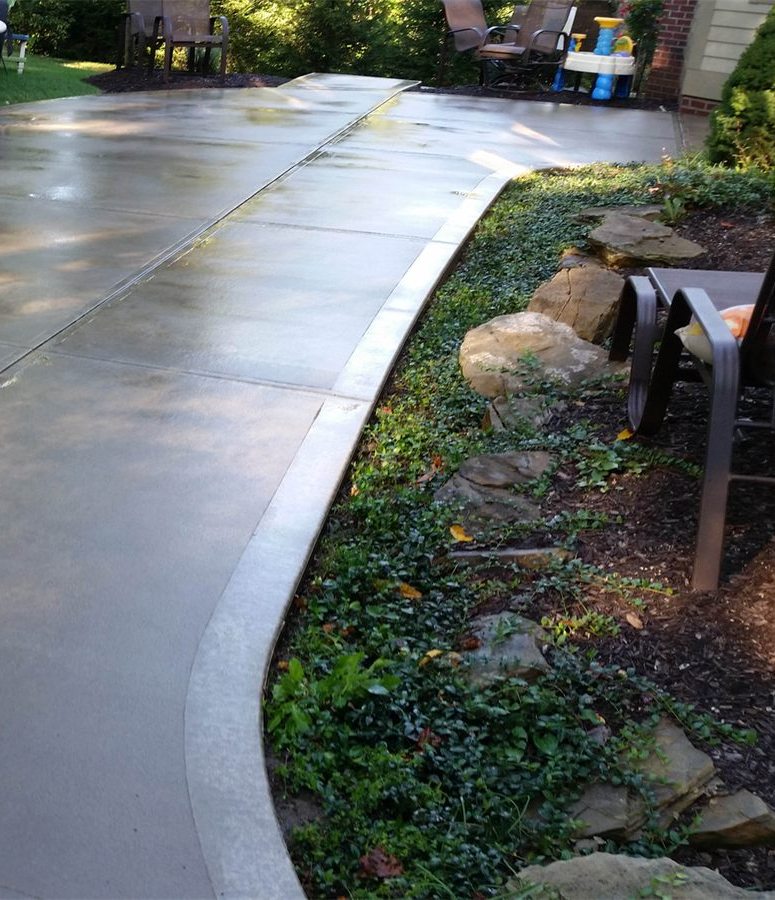 Clean residential concrete patio and walkway after pressure washing