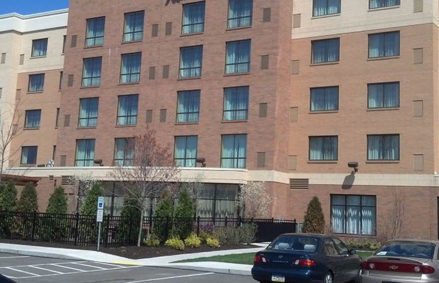 Multi-storey brick hotel exterior serviced by Flying Squeegees